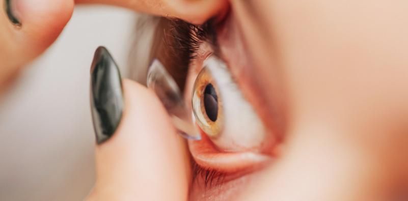 Woman putting contact lens